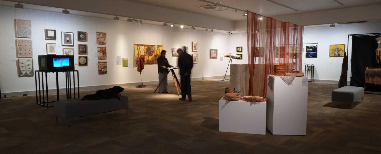 Terra-Rara Rare Earth installation showing group viewing Artist book on repurposed Theodolite stand